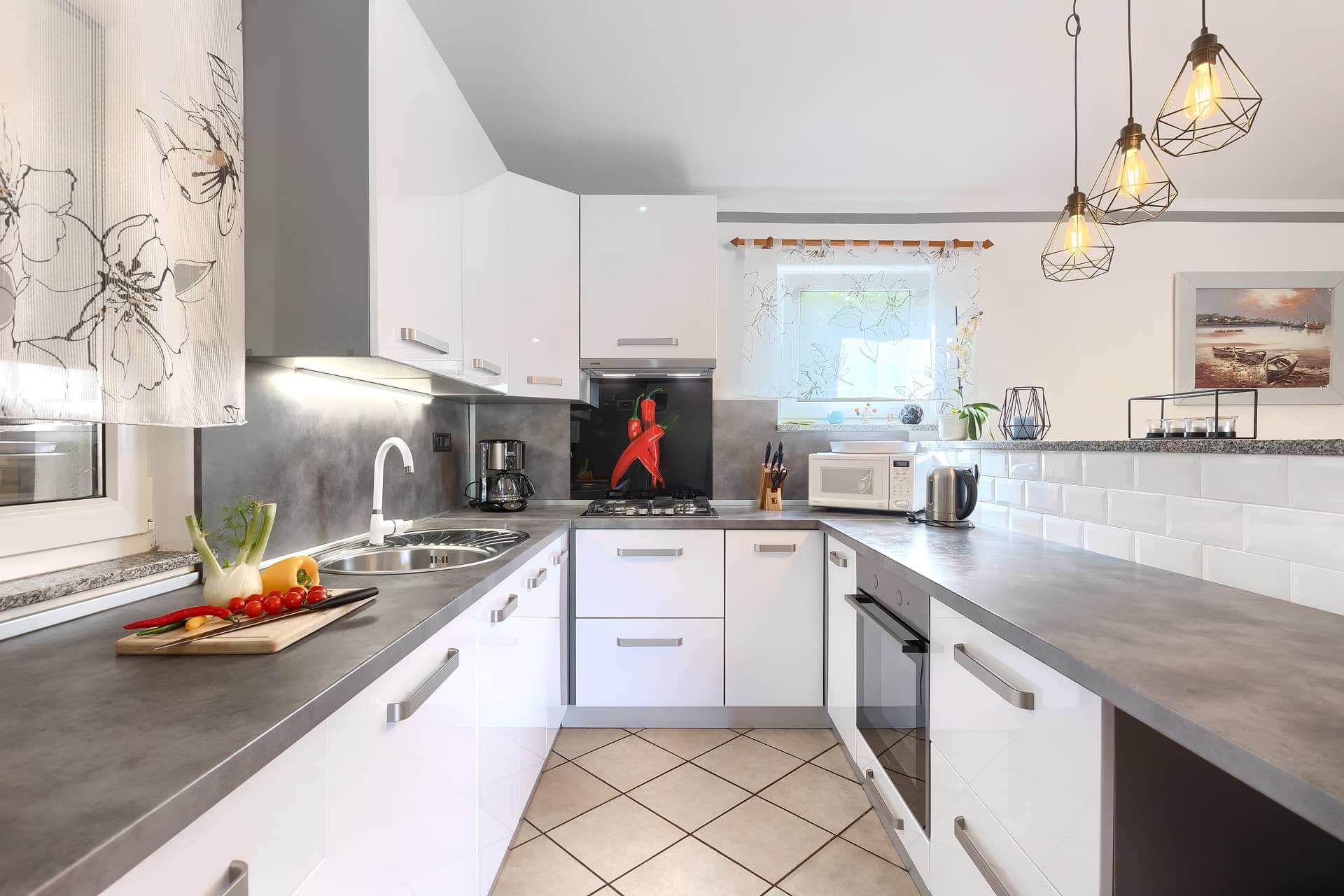 Fully equipped modern kitchen at Villa Rasovic featuring a large double-door refrigerator and coffee maker.