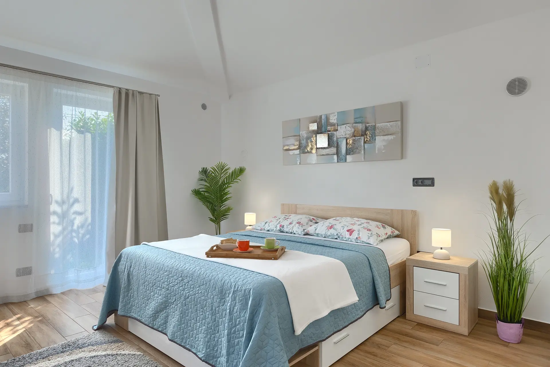 Bright and comfortable double bedroom at Villa Rasovic with modern decor and garden view.