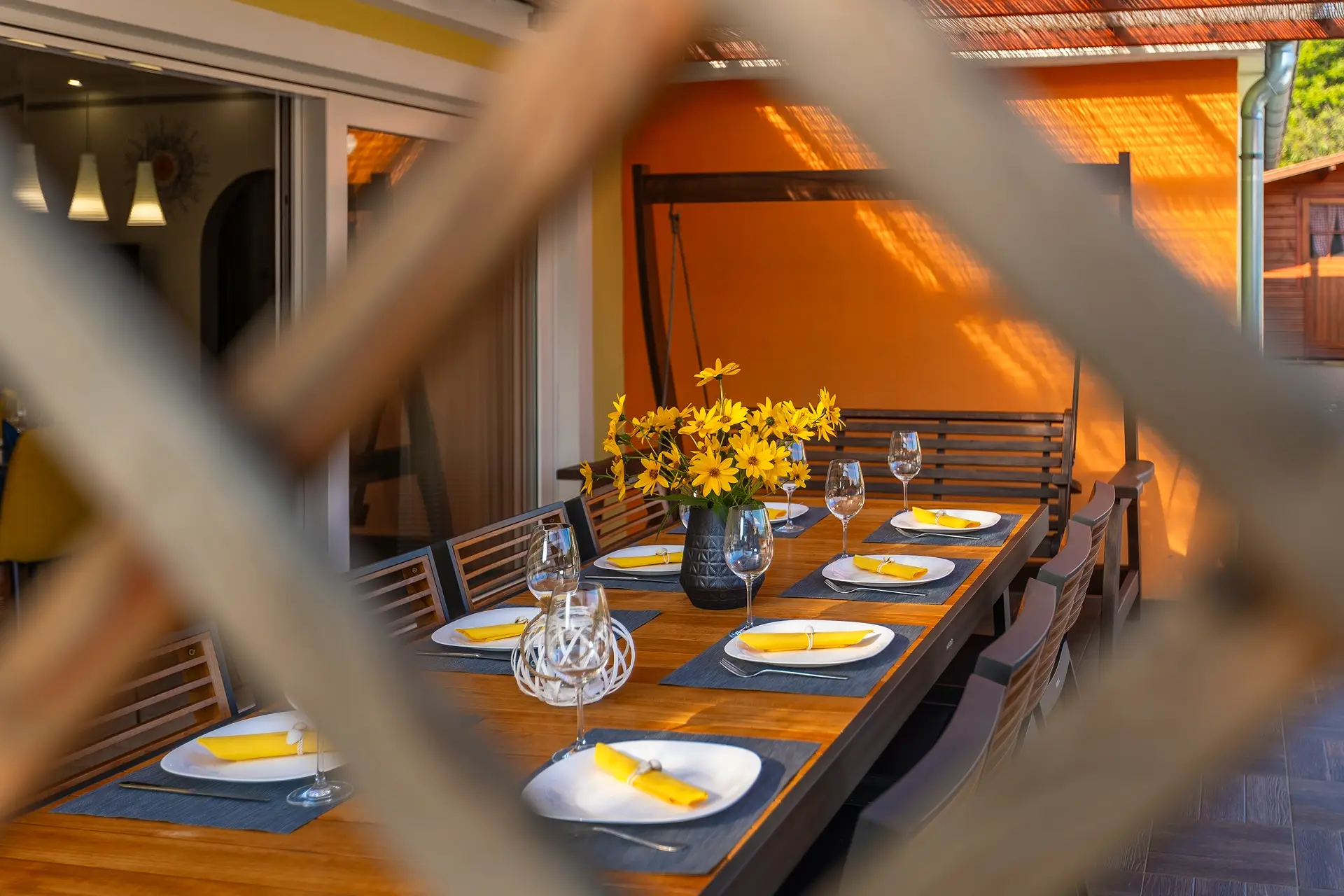 Al fresco dining setup with yellow flowers and wine glasses at Villa Rasovic.