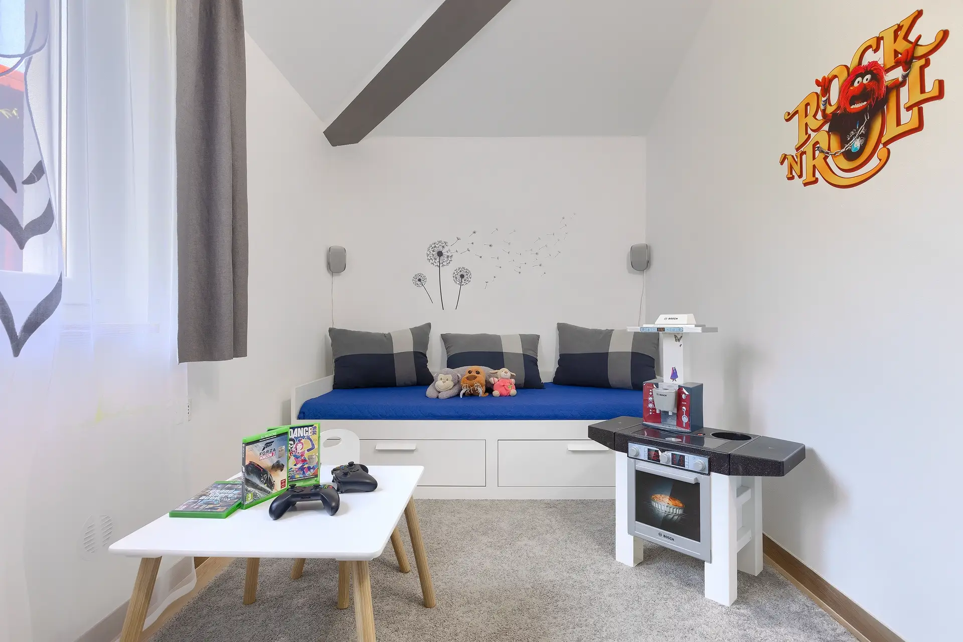 layroom area with toys and video games for kids.